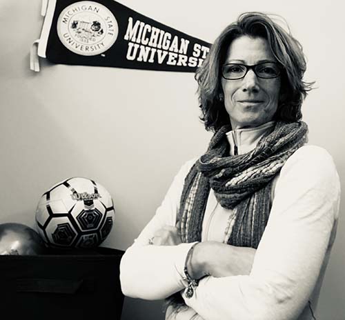 Dr. Becky Battista stands in her office