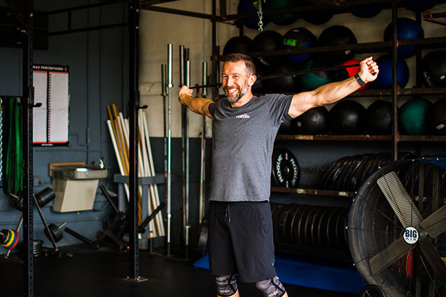 Dr. Ben Sibley smiles while at a weight machine