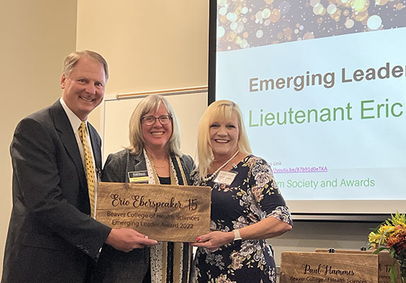 Dean Marie Huff presents award to a couple Eberspeakers