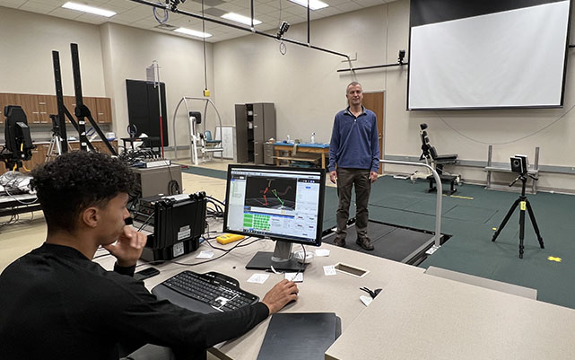 Dr. Herman van Werkhoven demonstrates in biomechanics lab