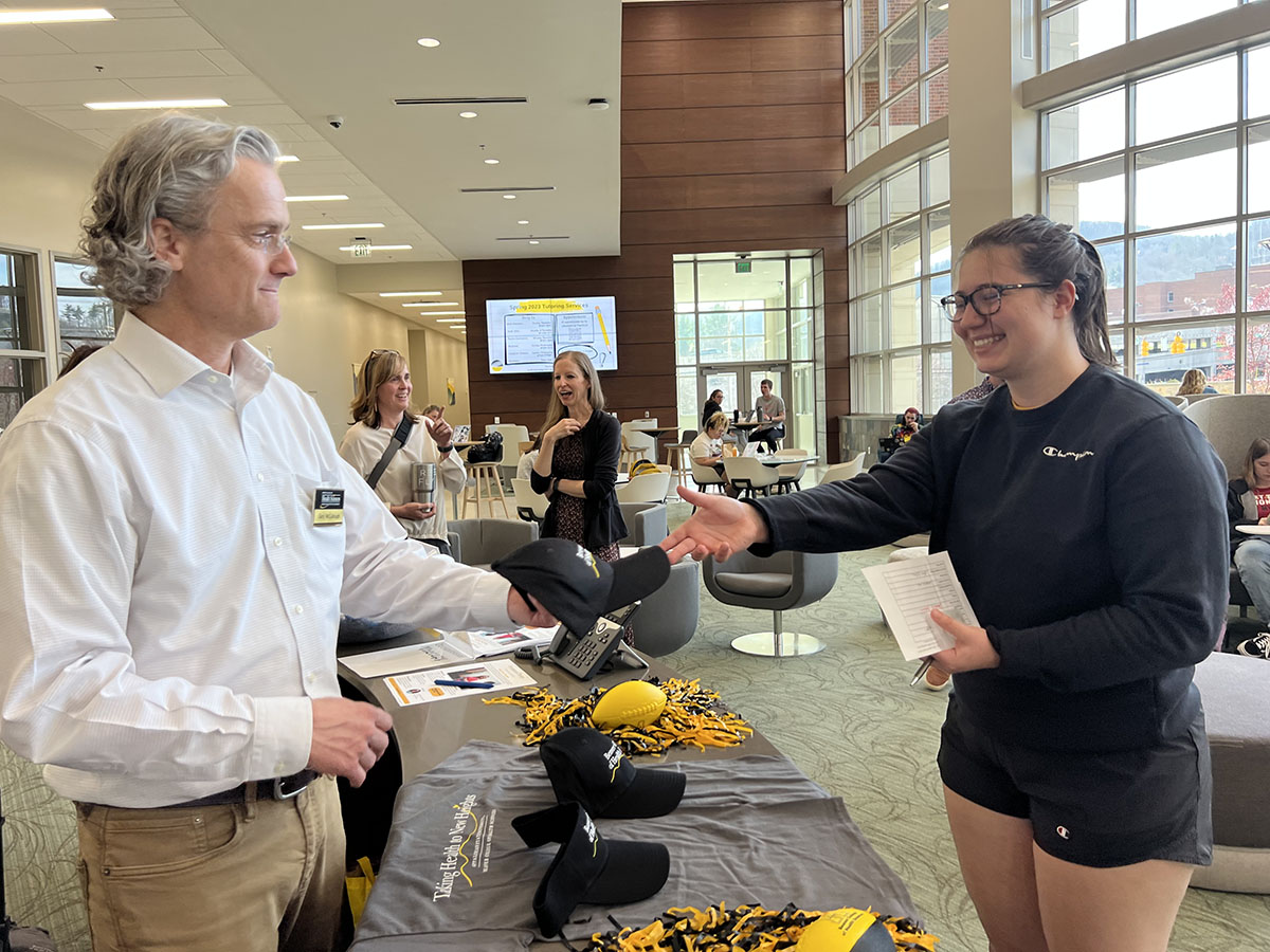 Dr. Gary McCullough provides some college swag at IPE Fair