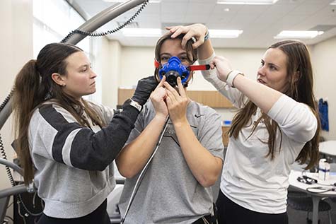 Kinesiology students lifting weights