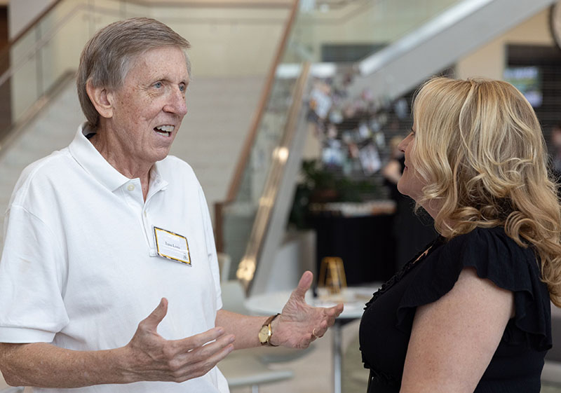 Dr. Lynn Lewis Talks To A Woman At Atrium Dedication Event