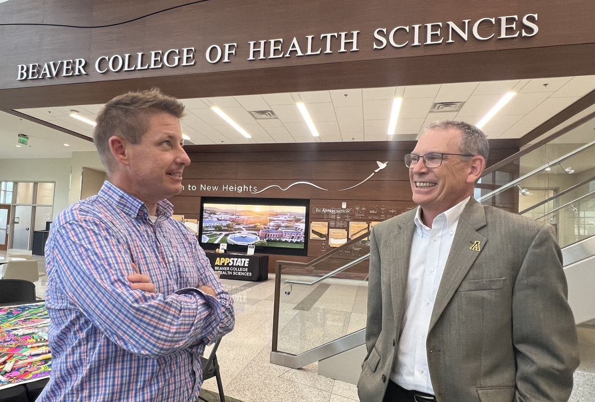 Jeff McPherson (left) talks with Dr. Adam Hege in Levine Hall