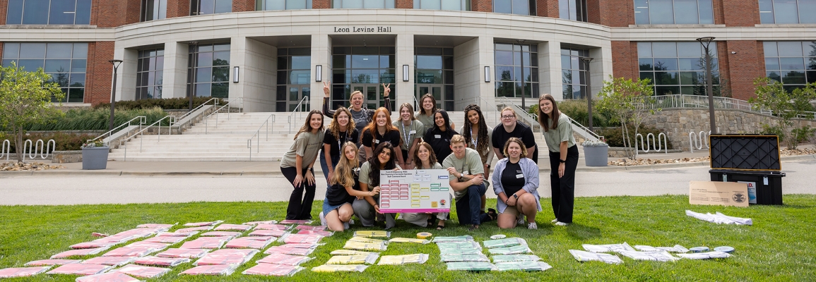 Public Health AmeriCorps group stands outside Levine Hall 