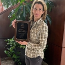 Woman holds a plaque