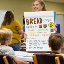 App State’s Lauren Sims, a speech-language pathology graduate student from Monroe, center in foreground, provides young students with directions for an activity in App State’s summer 2022 language and reading literacy program. The program, held as part of a summer literacy program offered at the Boone United Methodist Church, pairs healthy snack preparation and sampling with a speech-language pathology curriculum to help children improve their language and literacy skills. Photo by Chase Reynolds