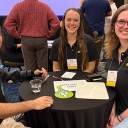 Three students wearing App State shirts sit around a table together 