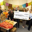 A group of people holding a check that reads $50,000