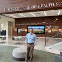Dr. Mark Trahan stands in the lobby of Levine Hall