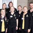 Group of people wearing App State scrubs stand together 