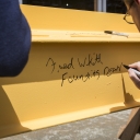 Founding Dean Fred Whitt signs the beam