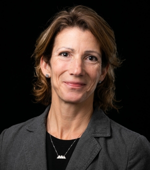 Image of woman wearing a blazer who is smiling 