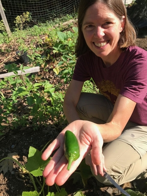 Woman holding a garden pepper in her palm