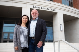 App State alumnus Dr. Ed Rankin ’79, right, and his wife, Thuy Le, of Dallas, Texas, contributed funds to launch a camp for adolescents who stutter, to be held annually on the App State campus beginning summer 2023. They are pictured in front of App State’s Leon Levine Hall of Health Sciences. Photo by Chase Reynolds