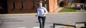 First-year student Lainie Baumgardner, of Waxhaw, runs on Appalachian State University’s campus Nov. 18 with her mask at the ready. She is a member of App State’s track and field team. It’s important to keep up physical activity throughout the winter for mental and physical health and immune system support, says App State’s Dr. Rebecca “Becki” Battista, an Exercise Is Medicine Ambassador and a board member of the Physical Activity Alliance. Photo by Marie Freeman