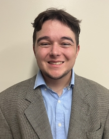 Connor Flannery Young man wearing a blazer smiles